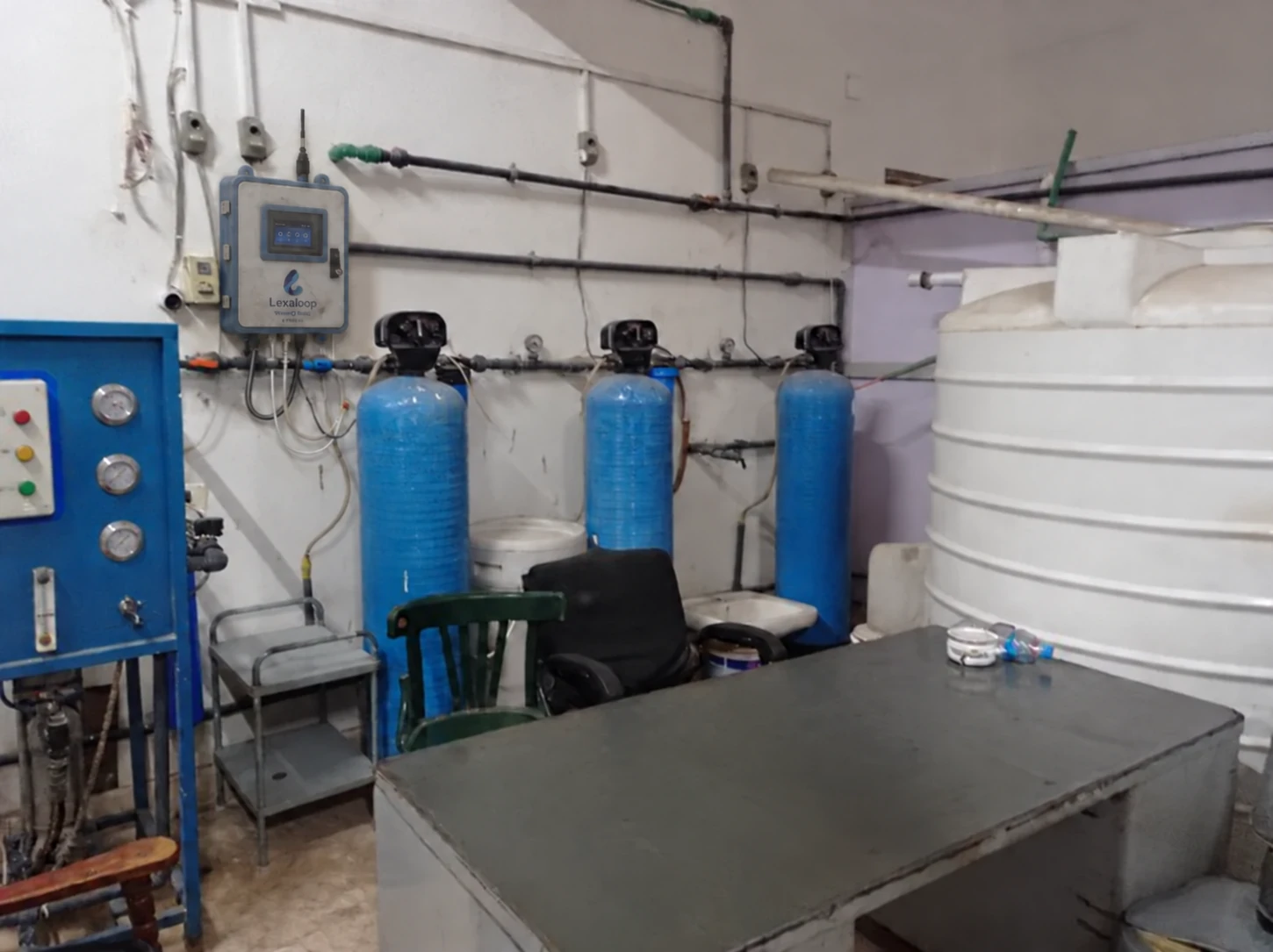 Treated-water and storage room with a Lexaloop WaterQ Basic analyzer digitally added to the wall beside the filters